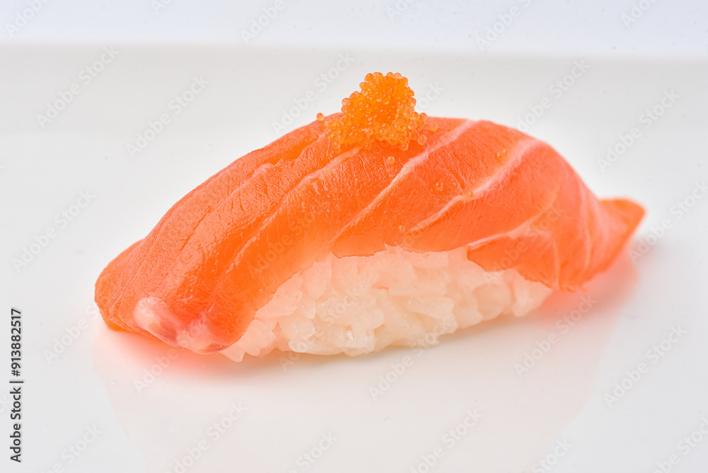 Salmon sushi topped with shrimp eggs, ready to eat