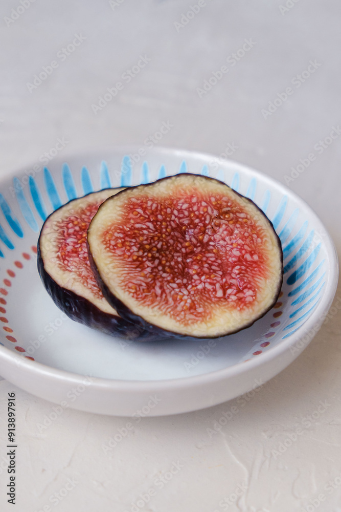 Beautiful fresh sliced black figs on white background Beautiful fresh sliced black figs on white background