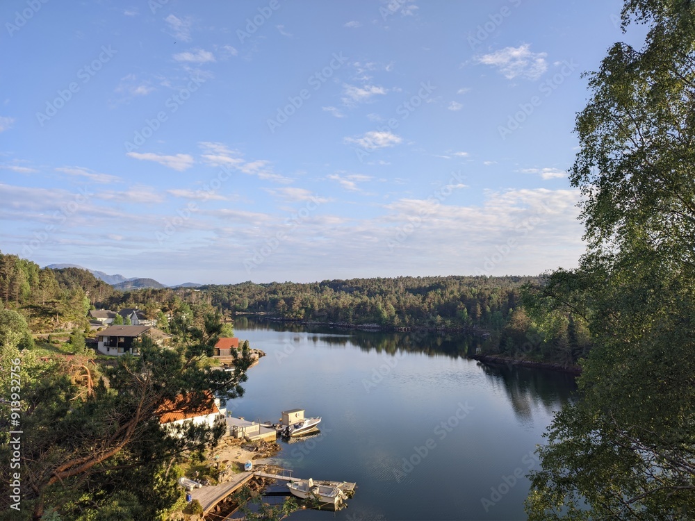 Enjoy a picturesque view of a serene lake landscape with clear blue skies and lush greenery Enjoy a picturesque view of a serene lake landscape with clear blue skies and lush greenery