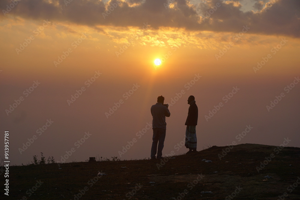 silhouette of a couple walking on a sunset background silhouette of a couple walking on a sunset background
