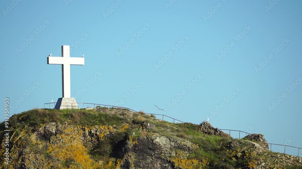 White Cross Atop a Hilltop with Seagulls