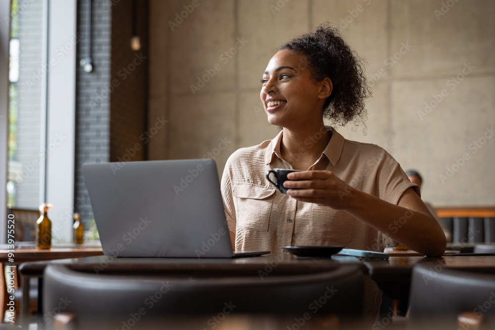 Young female freelancer working from a cafe Young female freelancer working from a cafe