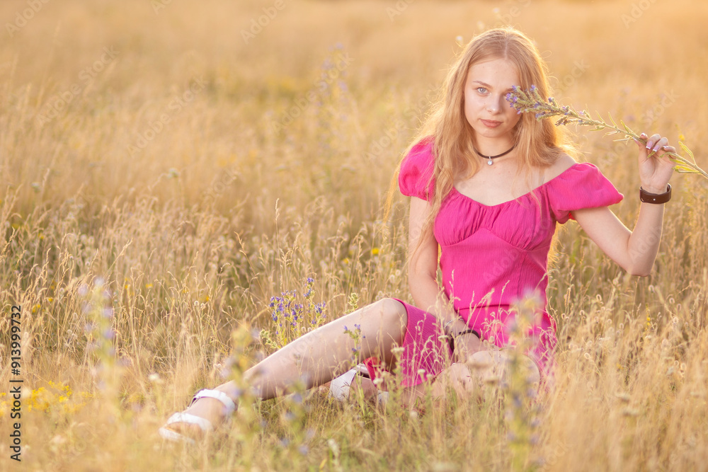 A beautiful Ukrainian girl on a wheat field in the rays of the sun A beautiful Ukrainian girl on a wheat field in the rays of the sun