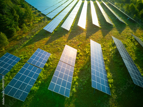 Solar panel produces green, environmentaly friendly energy from the setting sun. Aerial view from drone. Green energy production on the field. photo