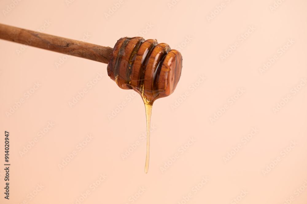 honey dripping from a honey spoon honey dripping from a honey spoon