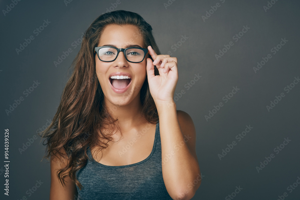 Portrait, woman and laughing with glasses in studio for space, eye care and lens joke of prescription frame. Happy, girl and eyewear for consultation, ophthalmology and funny comic on grey background Portrait, woman and laughing with glasses in studio for space, eye care and lens joke of prescription frame. Happy, girl and eyewear for consultation, ophthalmology and funny comic on grey background