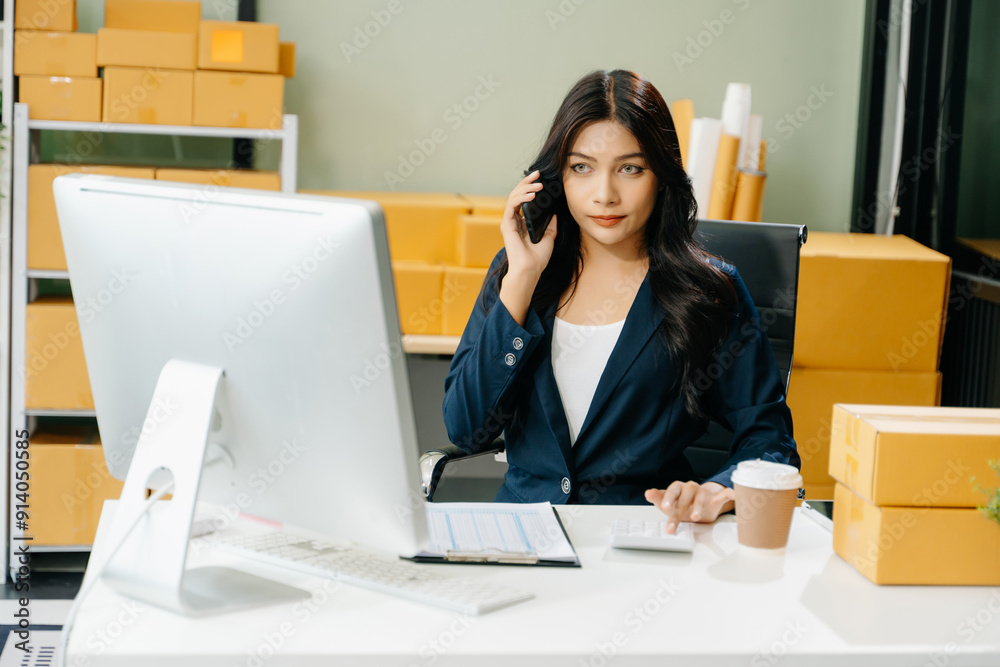 Young business owner woman prepare parcel box and standing check online orders for deliver to customer