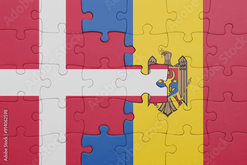 puzzle with the colourful national flag of moldova and flag of denmark.