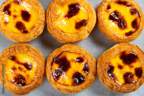 top view portuguese egg tarts in a box at horizontal composition photo