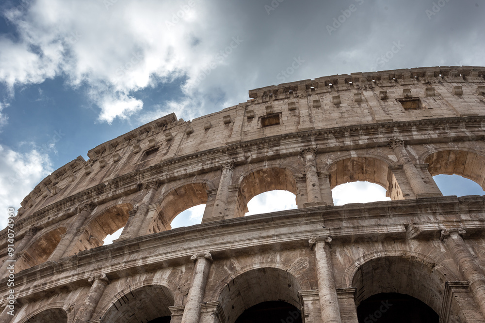 Fototapeta premium Wall of stone making up the Roman Colosseum on a cloudy day