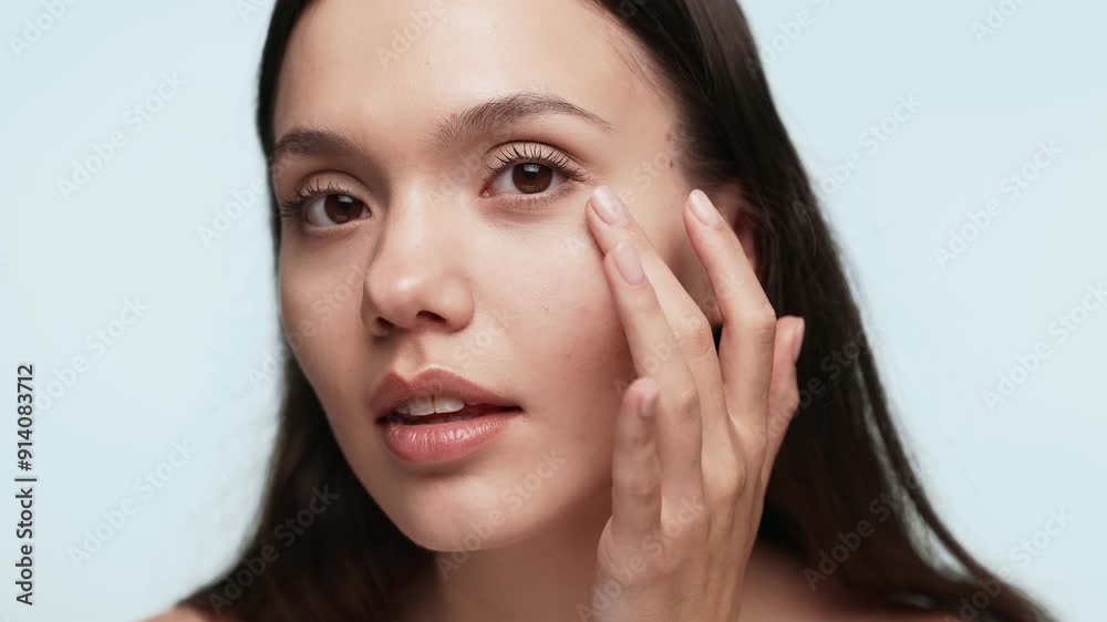 Closeup image of a young woman attentively fixing her makeup, suggesting preparations for an evening occasion. Closeup image of a young woman attentively fixing her makeup, suggesting preparations for an evening occasion.