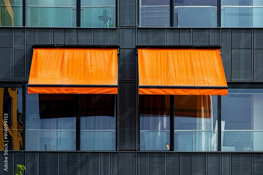 Orange canvas awning shading glass windows with black aluminum frame Orange canvas awning shading glass windows with black aluminum frame