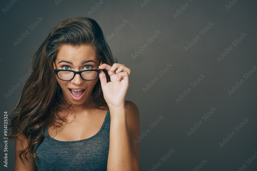 Portrait, woman and surprise with glasses in studio for space, eye care or wow lens of prescription solution. Shocked, girl and designer eyewear for consultation deal, gossip news and grey background Portrait, woman and surprise with glasses in studio for space, eye care or wow lens of prescription solution. Shocked, girl and designer eyewear for consultation deal, gossip news and grey background