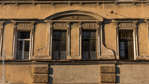 A very old and historic building that features many large windows