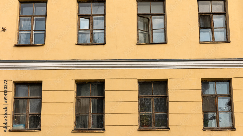 A tall building that features a large number of windows on its exterior A tall building that features a large number of windows on its exterior
