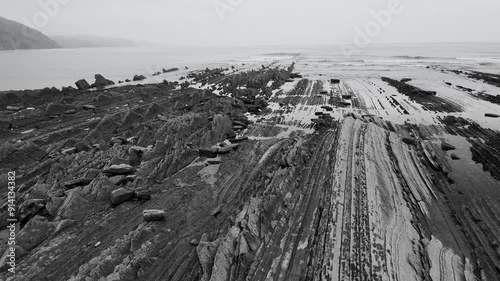 Rock textures at low tide at the Sakoneta Flysch and Punta Mendata on the Cantabrian Coast in Deva. Aerial view from a drone. Cantabrian Sea. Gipuzkoa Province. Basque Country. Spain. Europe photo