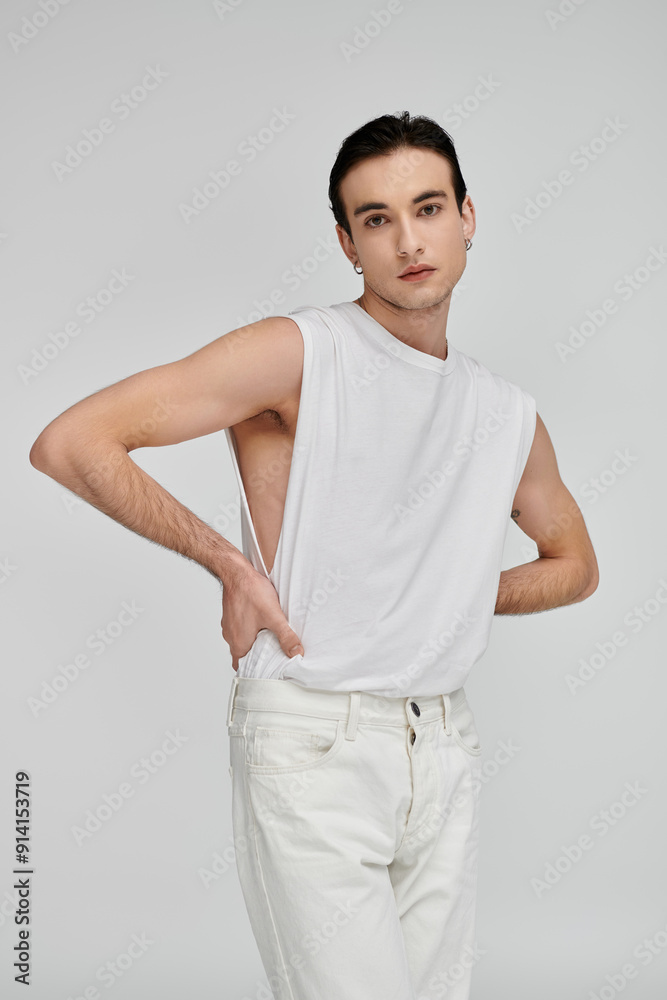 A man in white against a colorful background exudes elegance. A man in white against a colorful background exudes elegance.