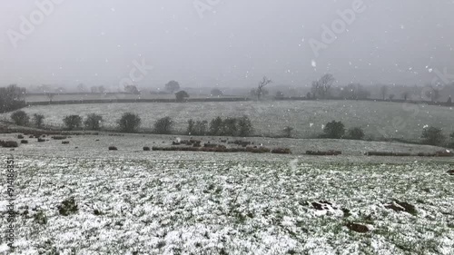 Snow falling across fields in April near Great Ayton, North Yorkshire, England, United Kingdom