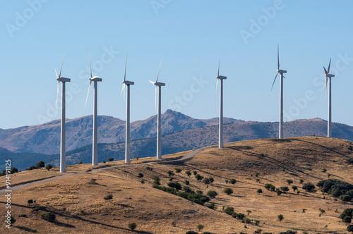 Majestic Wind Turbines Over Rolling Hills on a Clear Day