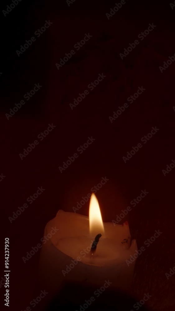 Vertical video. Close-Up of a Candle Inside a Halloween Pumpkin, Lighting the Candle, and the Smile and Scary Eyes Light Up in the Dark. Dolly Slider. Vertical video. Close-Up of a Candle Inside a Halloween Pumpkin, Lighting the Candle, and the Smile and Scary Eyes Light Up in the Dark. Dolly Slider.