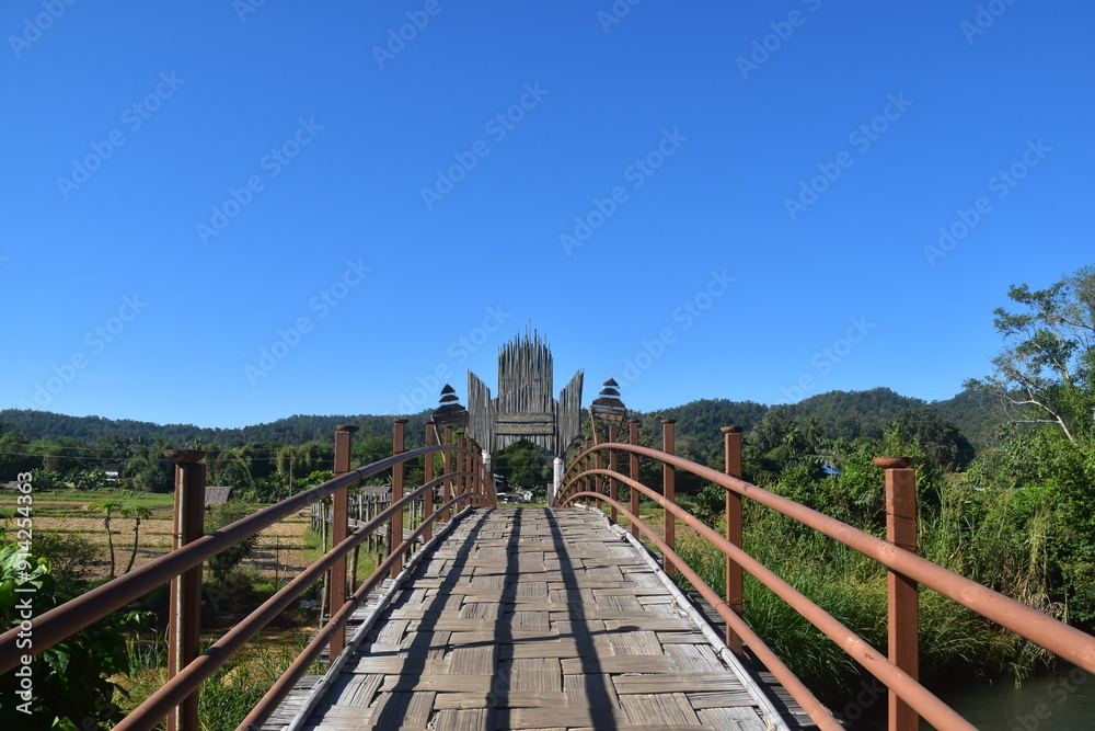 Wooden suspension bridges forming a hiking path on stilts over the wet rice fields in Northern Thailand Wooden suspension bridges forming a hiking path on stilts over the wet rice fields in Northern Thailand