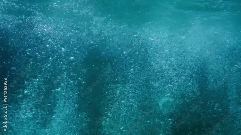 man jump in a pool with lots of air bubbles