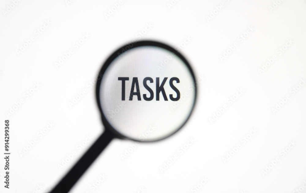 Word tasks on screen through magnifying glass close-up Word tasks on screen through magnifying glass close-up