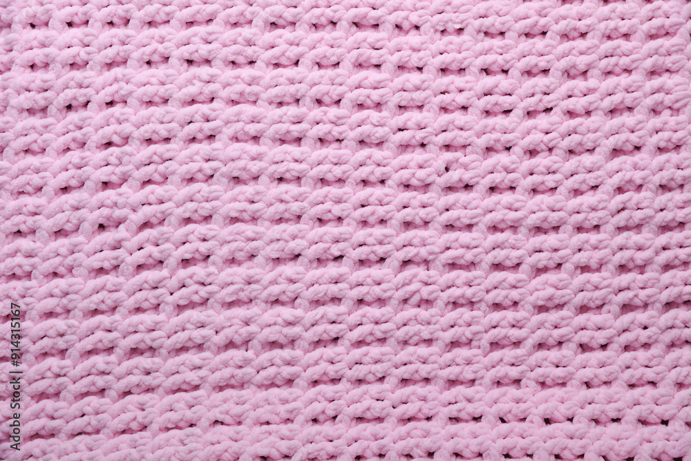 Texture of pink knitted plaid closeup