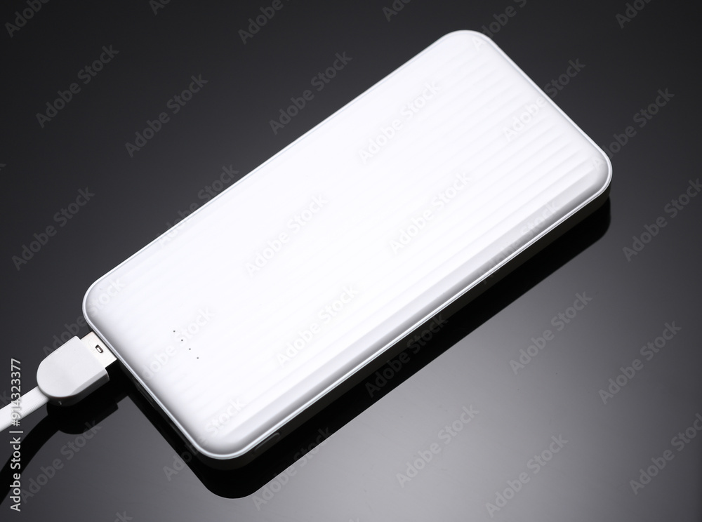 White power bank, external battery on a black background White power bank, external battery on a black background