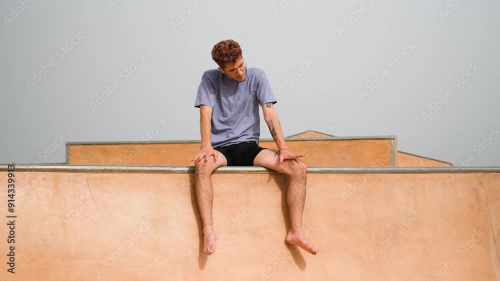 Young man lost in deep thought at skatepark edge, showing various expressions. Reflective and introspective moment captured
