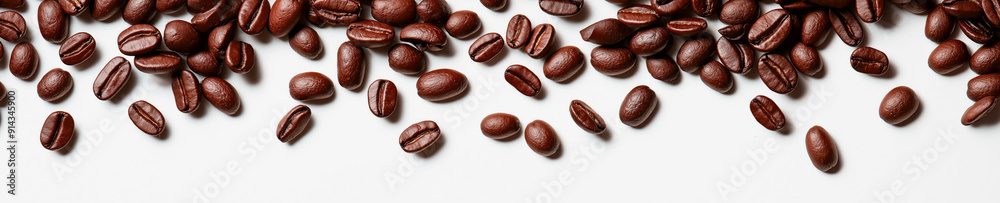 Coffee beans falling on a white background, top view, panorama. Coffee beans falling on a white background, top view, panorama.