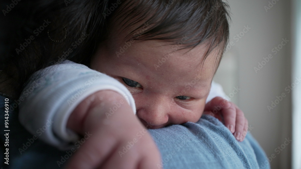 Newborn baby with peeling skin on the arm lying on a parent's shoulder, showing a close-up of the delicate hand and tender moments of early infancy Newborn baby with peeling skin on the arm lying on a parent's shoulder, showing a close-up of the delicate hand and tender moments of early infancy