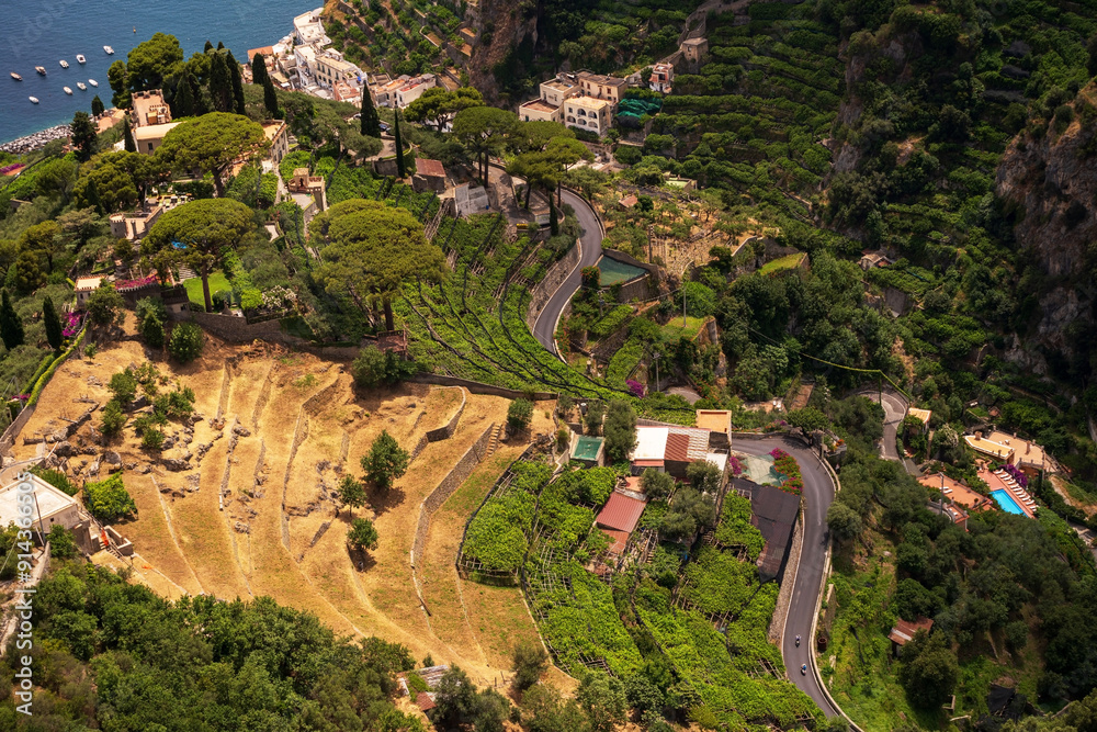 Aerial View of Beautiful Italian Countryside with Vineyards and Hills, curvy road aerial drone shot, Italy, Europe