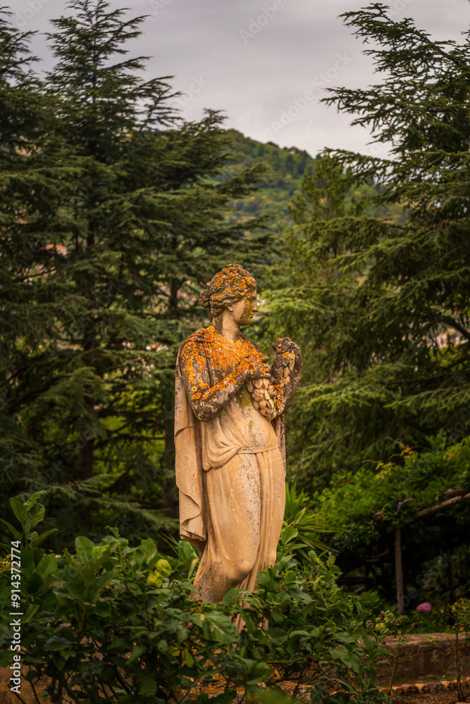 Ancient Stone Statue In Scenic Forest Garden Setting, Gardens of Villa Cimbrone villa in ravello, Italy, Europe