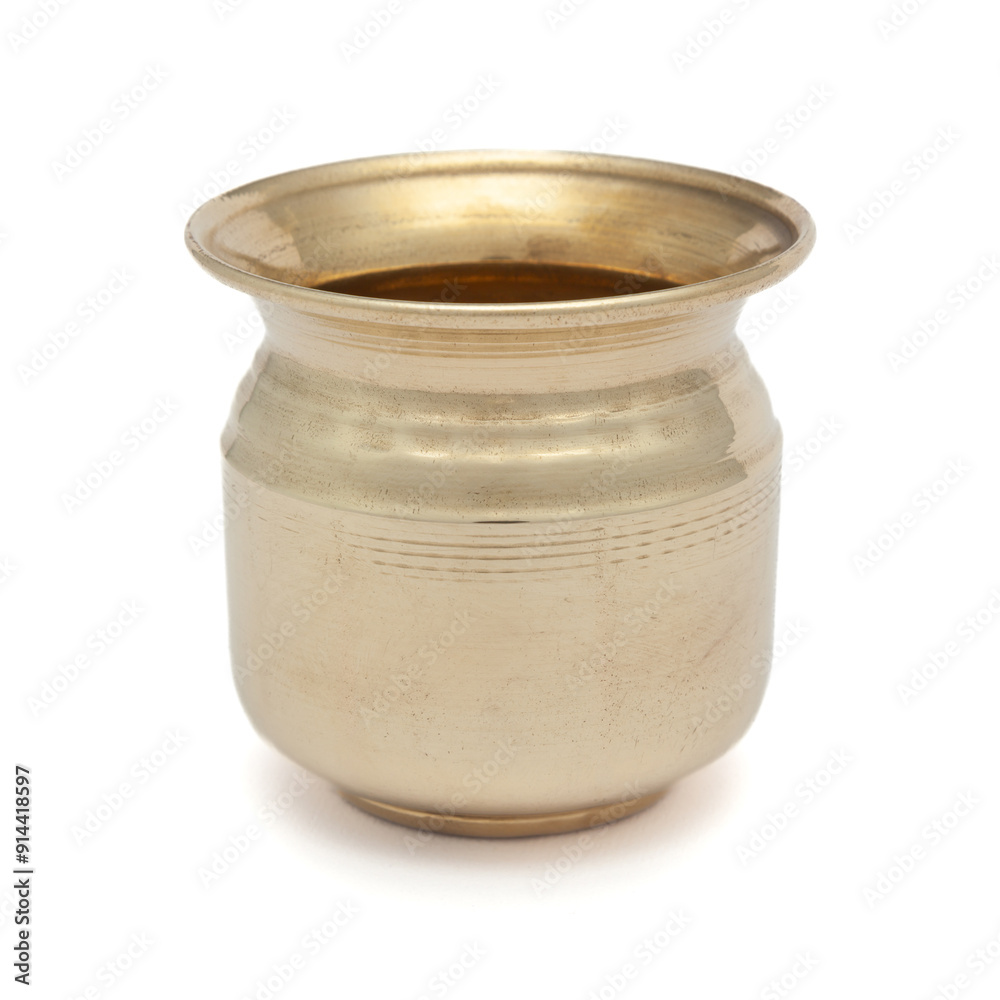 A brass 'Kalash' (lota), a traditional globular water container, placed on a white background, highlighting its cultural and utilitarian significance. A brass 'Kalash' (lota), a traditional globular water container, placed on a white background, highlighting its cultural and utilitarian significance.