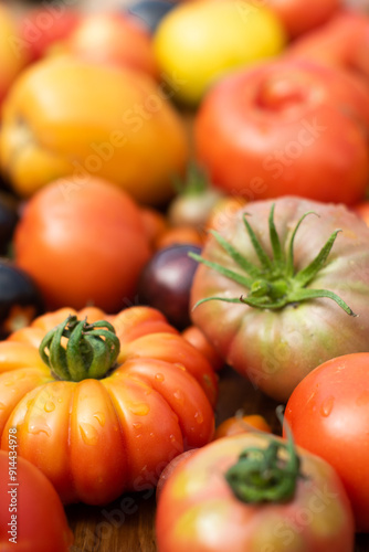 Self-grown garden tomatoes in many different varieties and colors, closeup with selective focus.