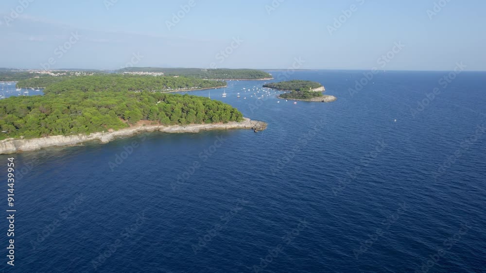 A stunning view captured by drone along the shores of the Mediterranean Sea. The beautiful Croatian coast during a summer vacation, with boats and yachts slicing through the sea waters. A stunning view captured by drone along the shores of the Mediterranean Sea. The beautiful Croatian coast during a summer vacation, with boats and yachts slicing through the sea waters.