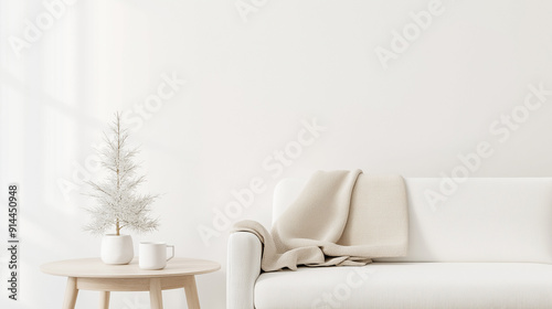 A white couch with a white blanket draped over it sits in front of a window