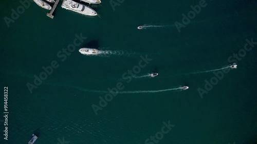A stunning view captured by drone along the shores of the Mediterranean Sea. The beautiful Croatian coast during a summer vacation, with boats and yachts slicing through the sea waters.