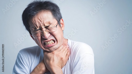 Person wincing from severe muscle cramp, pain, acute discomfort