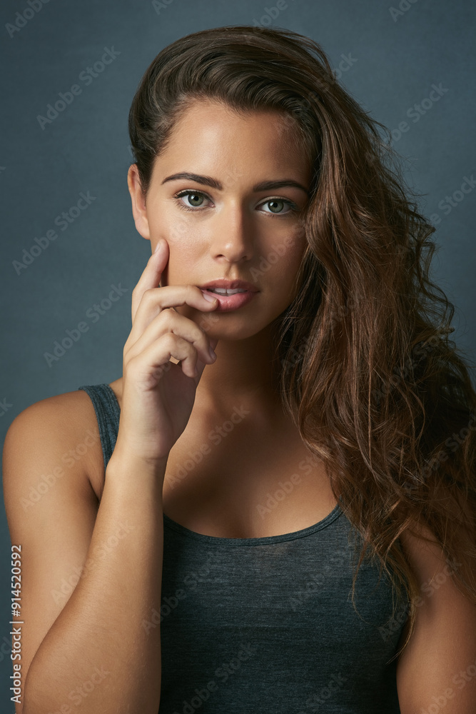 Hair care, growth and portrait of woman in studio for salon treatment, shampoo and results. Relax, makeup and female person with confidence for collagen, texture or cosmetics on blue background Hair care, growth and portrait of woman in studio for salon treatment, shampoo and results. Relax, makeup and female person with confidence for collagen, texture or cosmetics on blue background