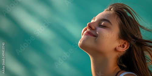 Relaxed Woman Smiling with Eyes Closed in Sunshine photo