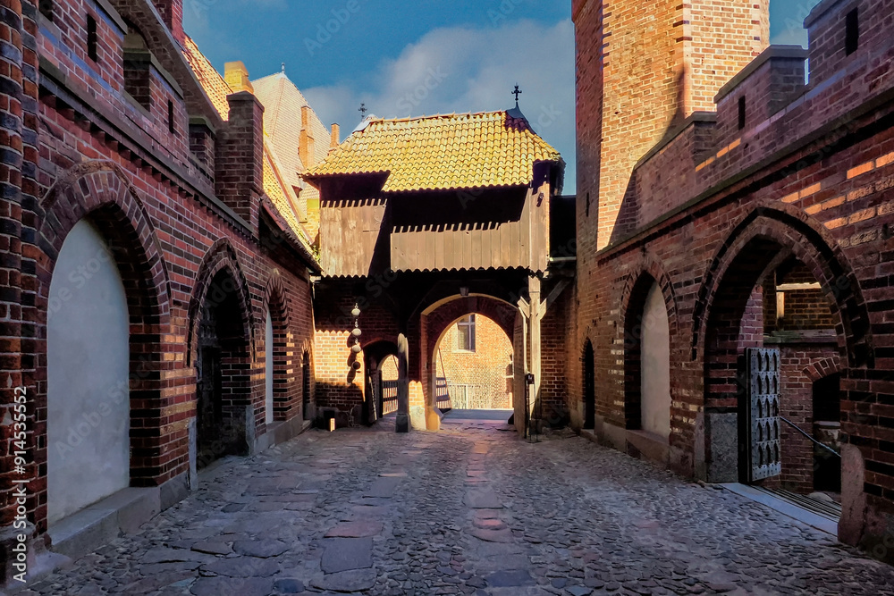 Fototapeta premium Malbork, Poland - the photo shows a fragment of the Teutonic Knights' castle, dedicated to the Blessed Virgin Mary. The castle was built in several stages from 1280 to the mid-15th century.