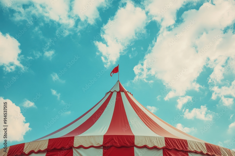 A circus tent with distinctive red and white stripes set against a bright blue sky, evoking a nostalgic and whimsical atmosphere. A circus tent with distinctive red and white stripes set against a bright blue sky, evoking a nostalgic and whimsical atmosphere.