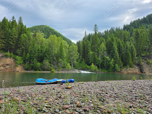 Rafts resting next to clear Montana stream