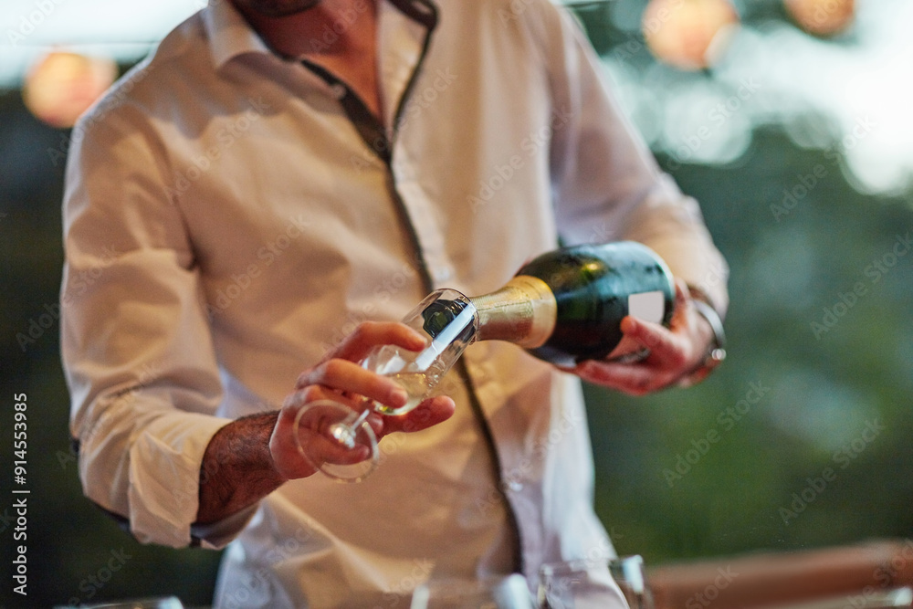 Champagne, glass and pour with hands of barman in restaurant for hospitality or service closeup. Alcohol, drink and wine with person serving beverage at event for celebration, milestone and toast Champagne, glass and pour with hands of barman in restaurant for hospitality or service closeup. Alcohol, drink and wine with person serving beverage at event for celebration, milestone and toast