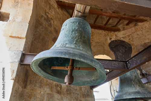 Bells in the bell tower of the Royal Clerecia of San Marcos in Salamanca, Castilla y Leon, Spain, with spanish shield photo