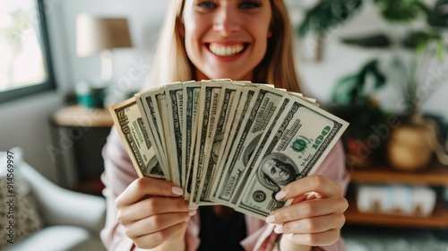 Close up of happy woman holding money with blurred background in a joyful gesture