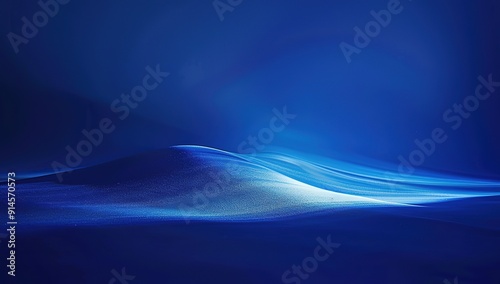 Blue light shines on a dark blue background,