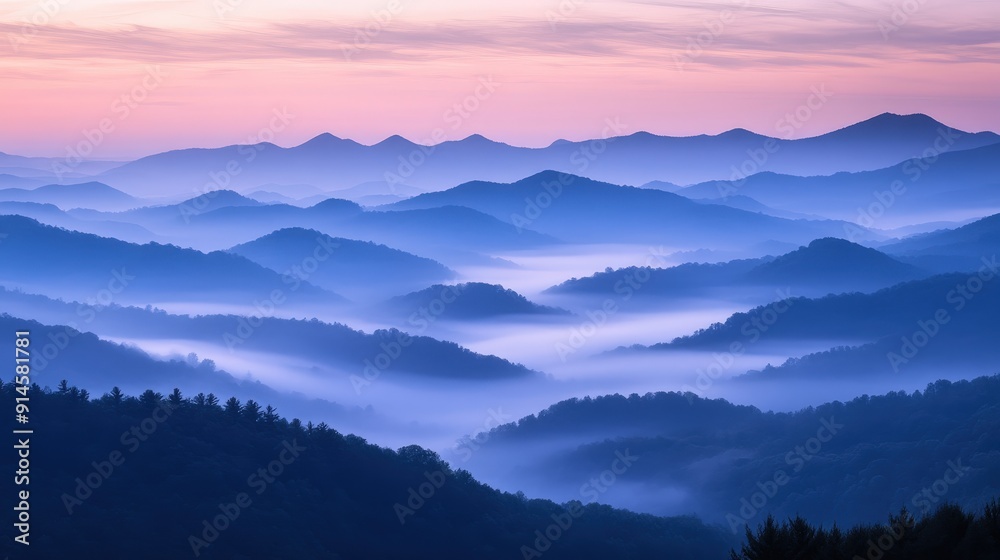 Fototapeta premium Serene Landscape of Foggy Mountain Range at Dawn with Soft Pastel Colors and Layered Peaks